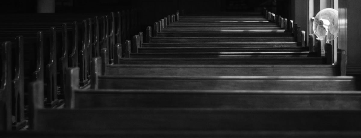 A line of pews in an empty church